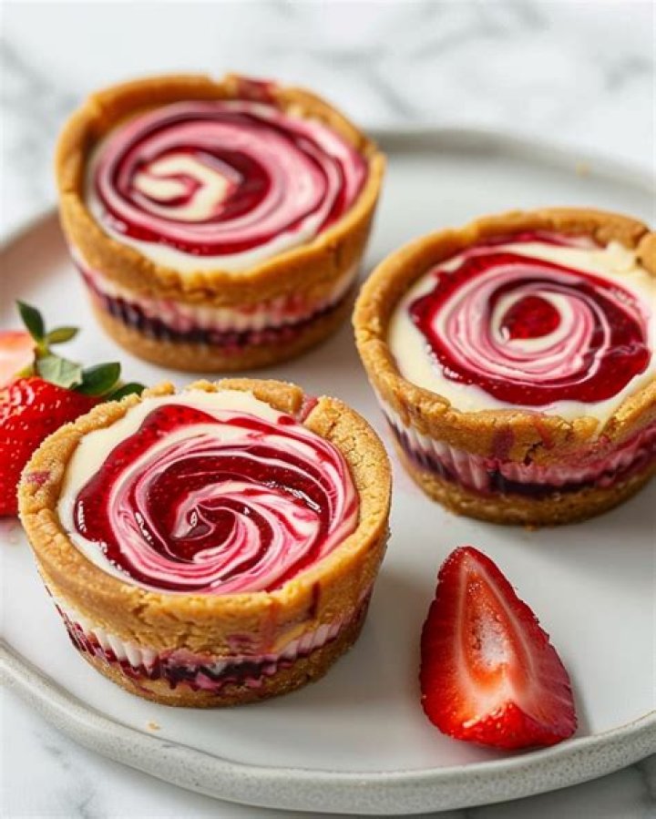 Cheesecake cookie with a swirl of frosting and jam in the center