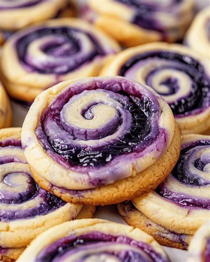 Cheesecake cookies with a swirl of frosting and jam in the center