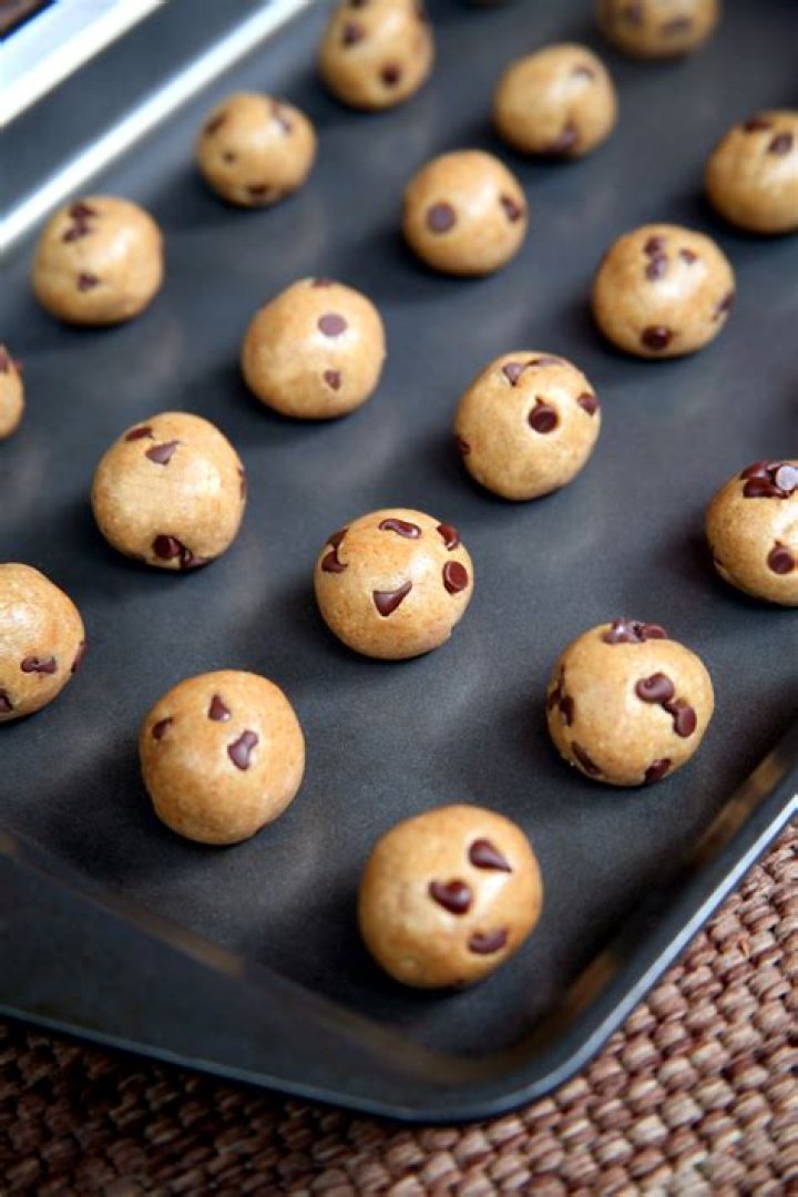 Cookie dough balls in a bowl with graham cracker crumbs