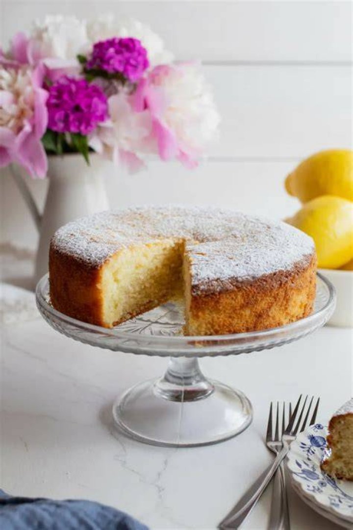 Glass bowl with lemon cake batter and fresh blueberries.