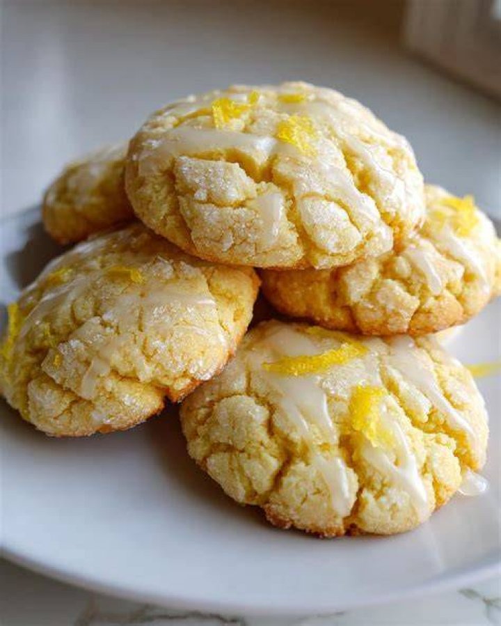 Stack of lemon cookies topped with white chocolate chunks.